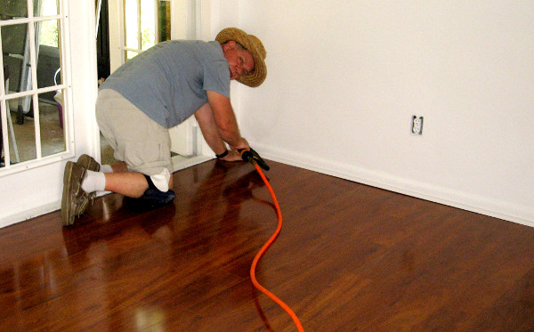 photo of Kristofer installing wood flooring
